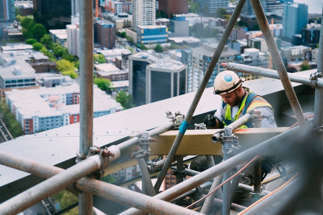 Construction worker wearing fall protection safety during work