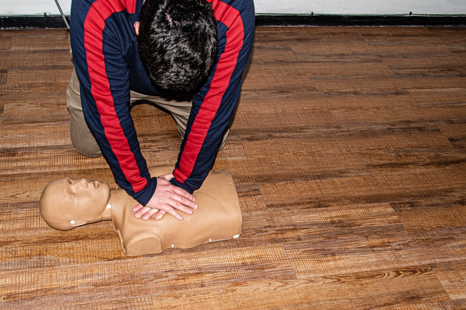 a person performing CPR on a dummy