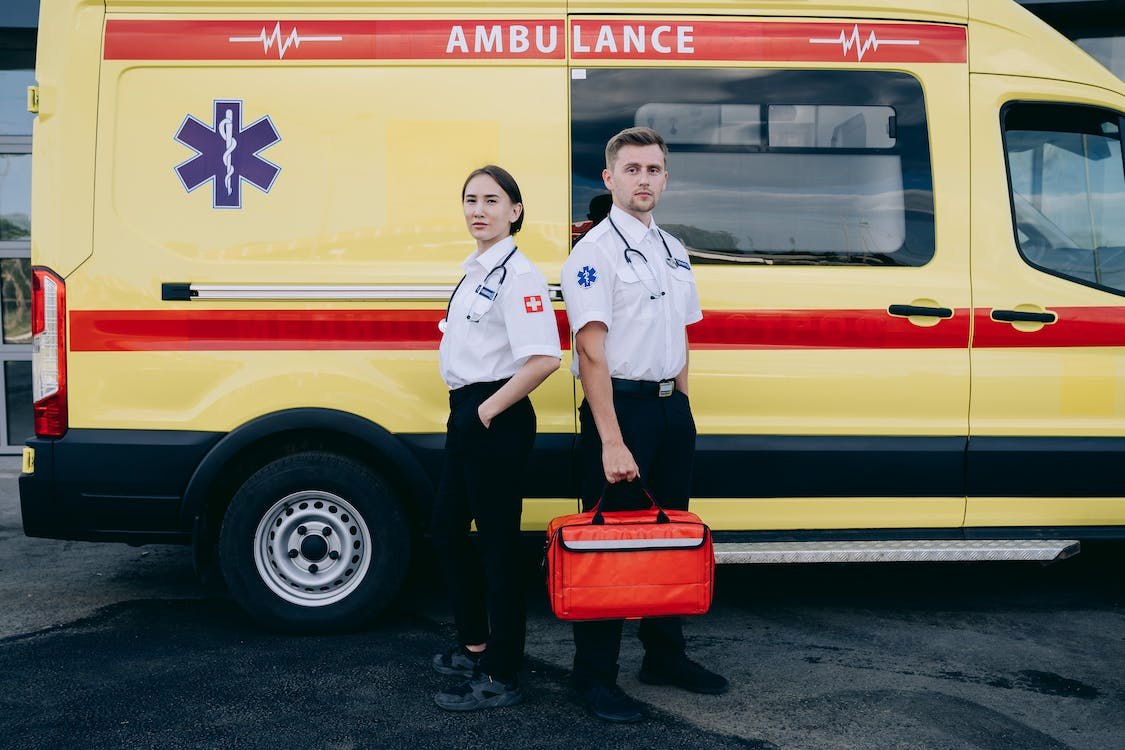 Paramedics standing next to an ambulance