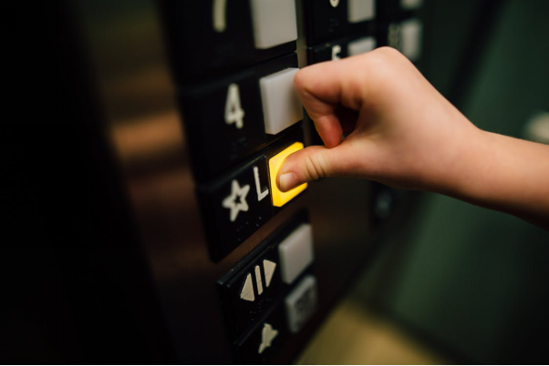 Person pressing elevator button
