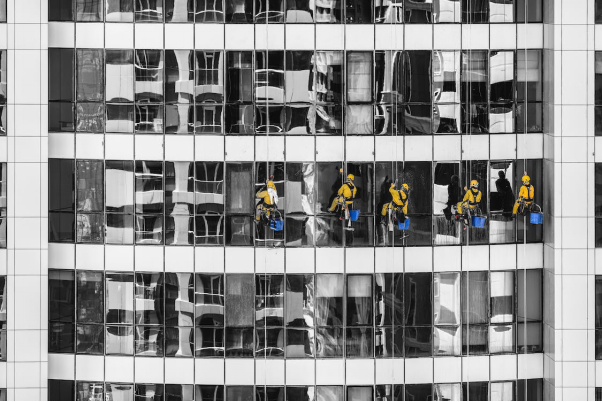 Five window cleaners on a building
