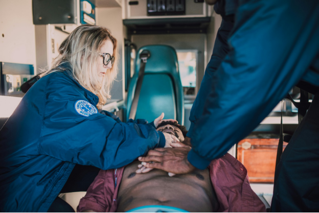 Paramedic performing CPR on a patient