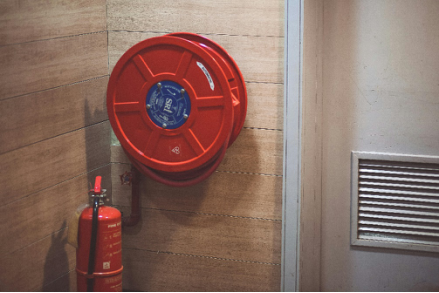 Fire extinguisher below a hose reel