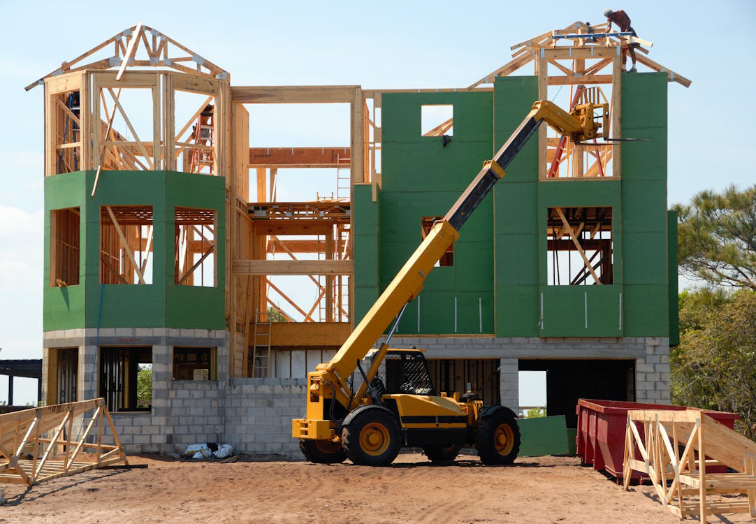 Workers on the roof of an unfinished residential structure