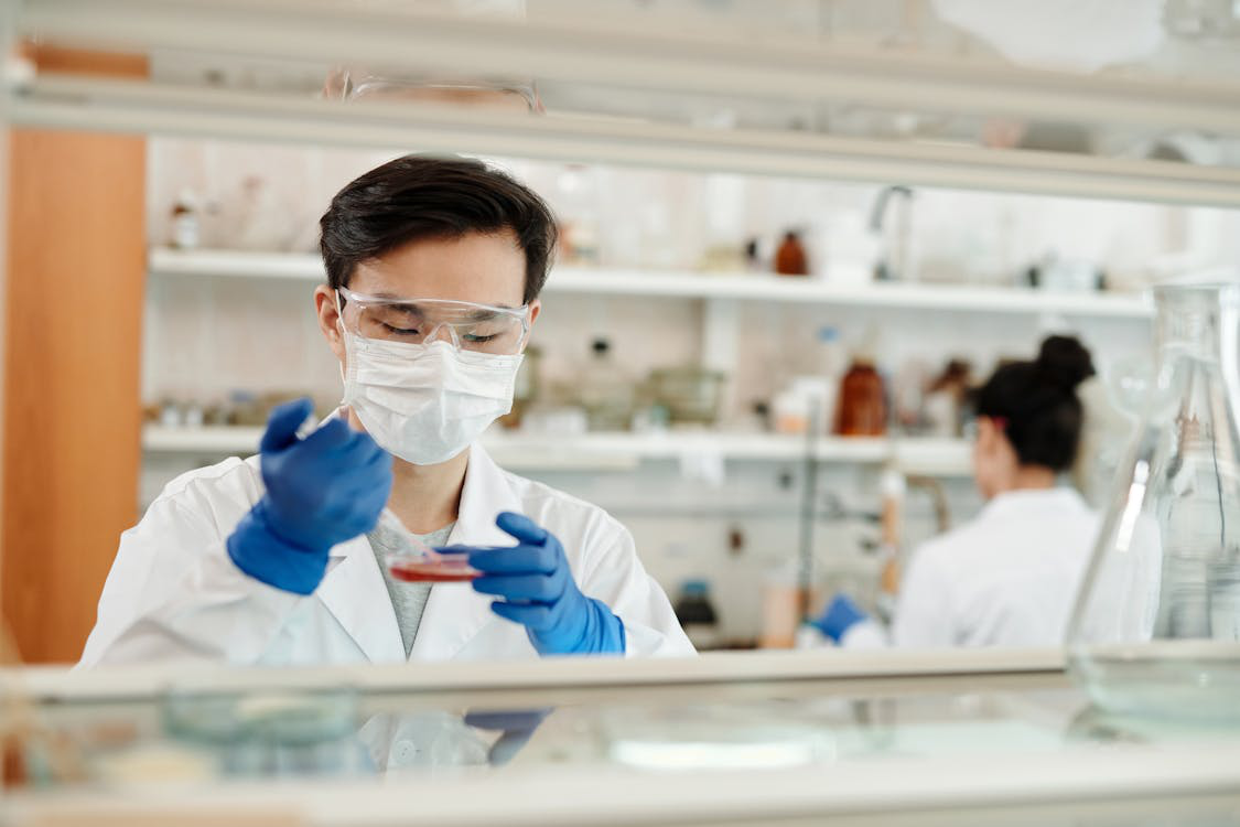 A man wearing proper PPE inside a chemical lab