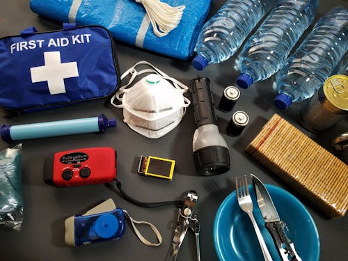 Open first aid survival kit showing various medical supplies