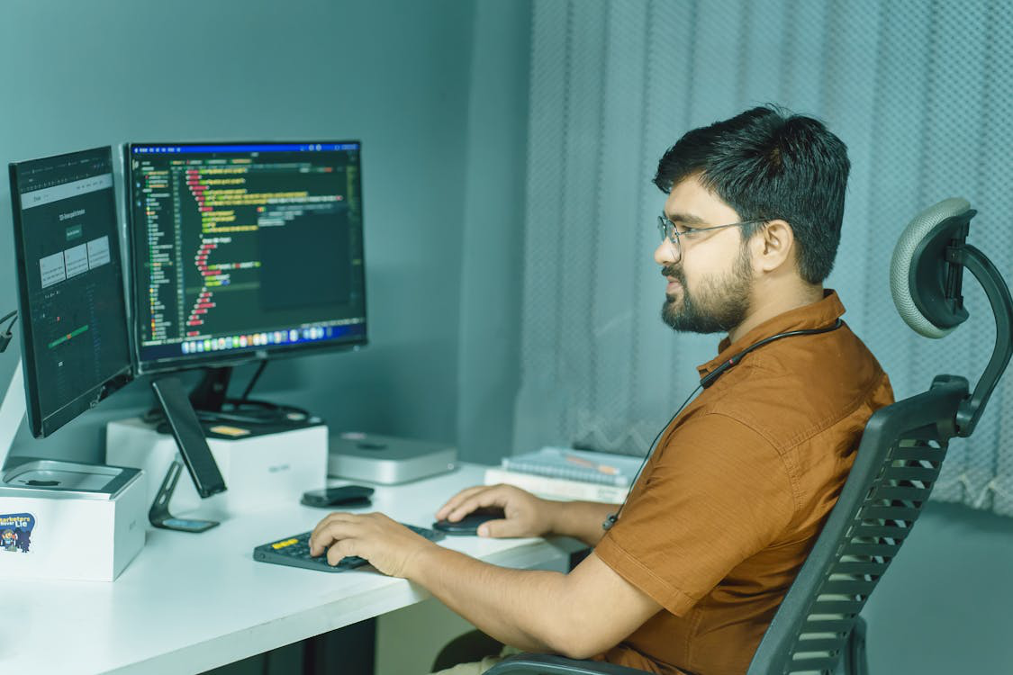 A person working on a computer with ergonomic seating