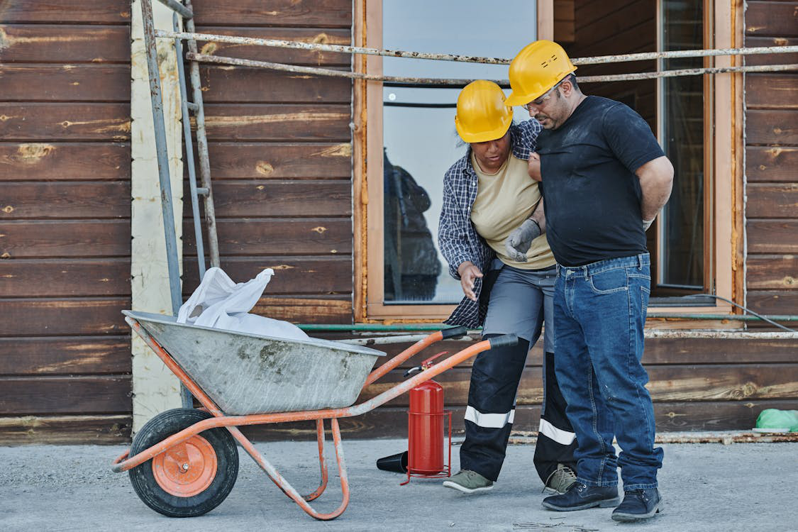 A worker supporting an injured colleague in a workplace setting