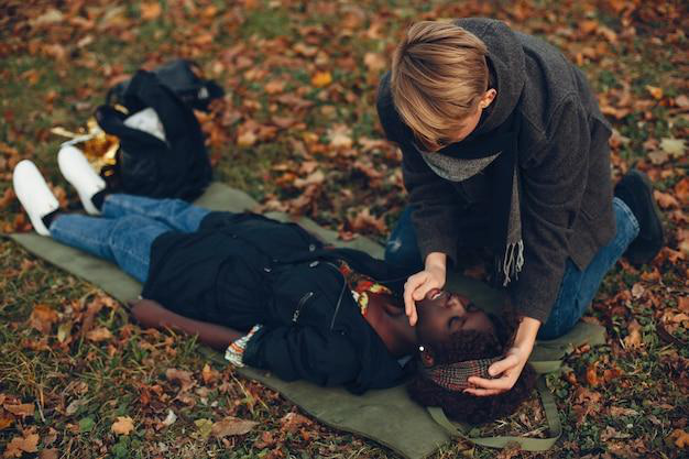  A person helping an unconscious woman