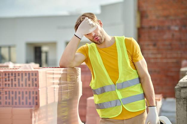 a construction worker feeling fatigue