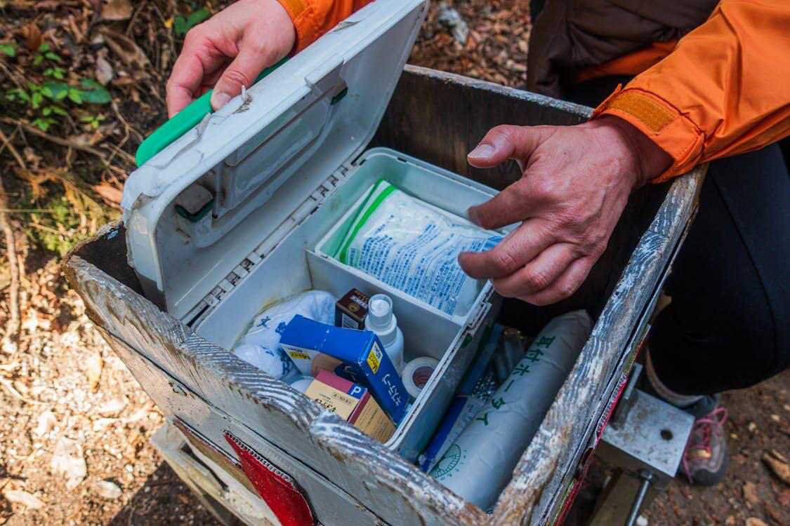 Close-up of a first aid kit with medical supplies.