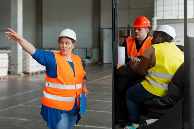 A forklift manager briefing her team